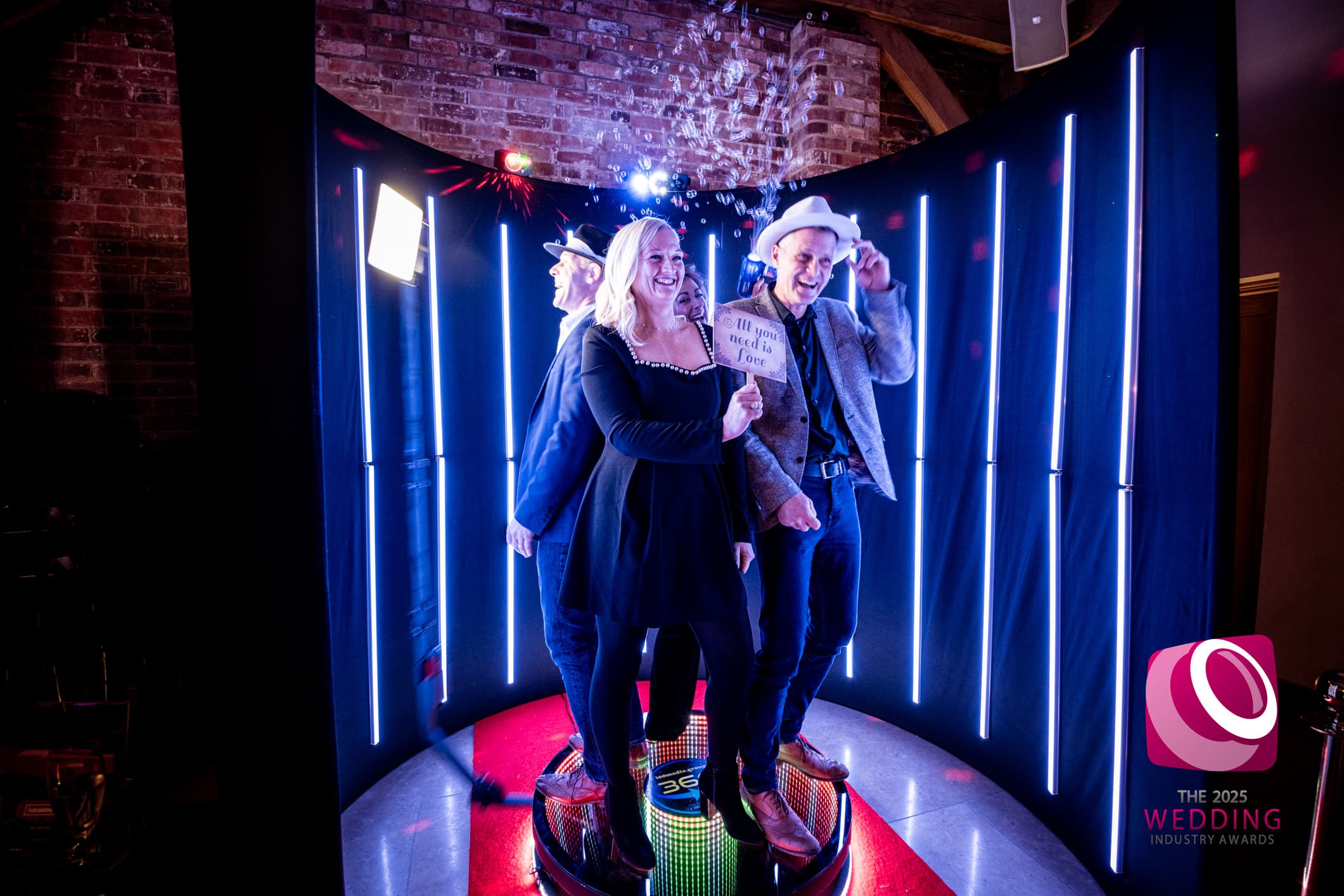 Couple dancing on a 360 photo booth platform at a wedding reception in Essex